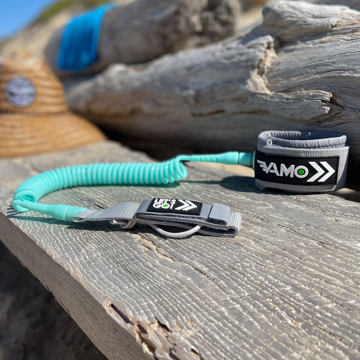 Teal leash with black and white handle on a wooden surface