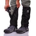 Person wearing black gaiters with a visible brand logo on a white background