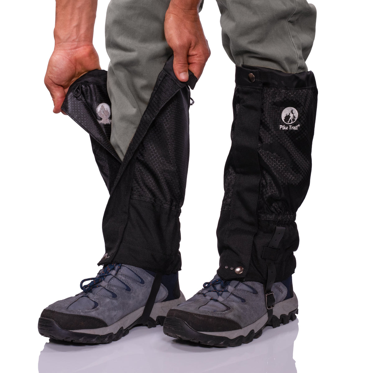 Person wearing black gaiters with a visible brand logo on a white background
