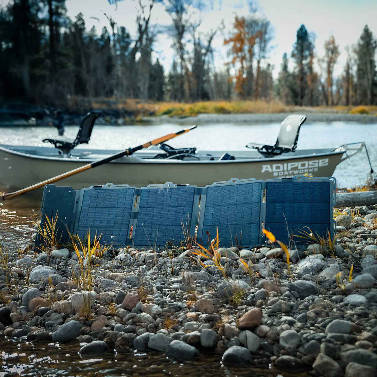 Kayak on a rocky shore with trees in the background