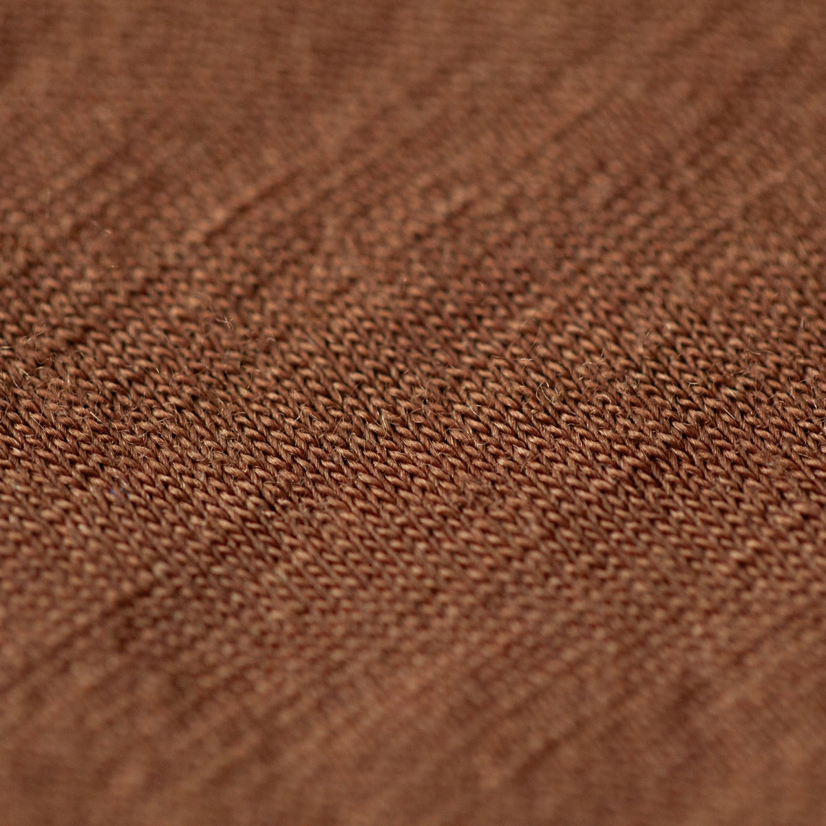 Close-up of a brown woven fabric texture with a fine ribbed pattern.