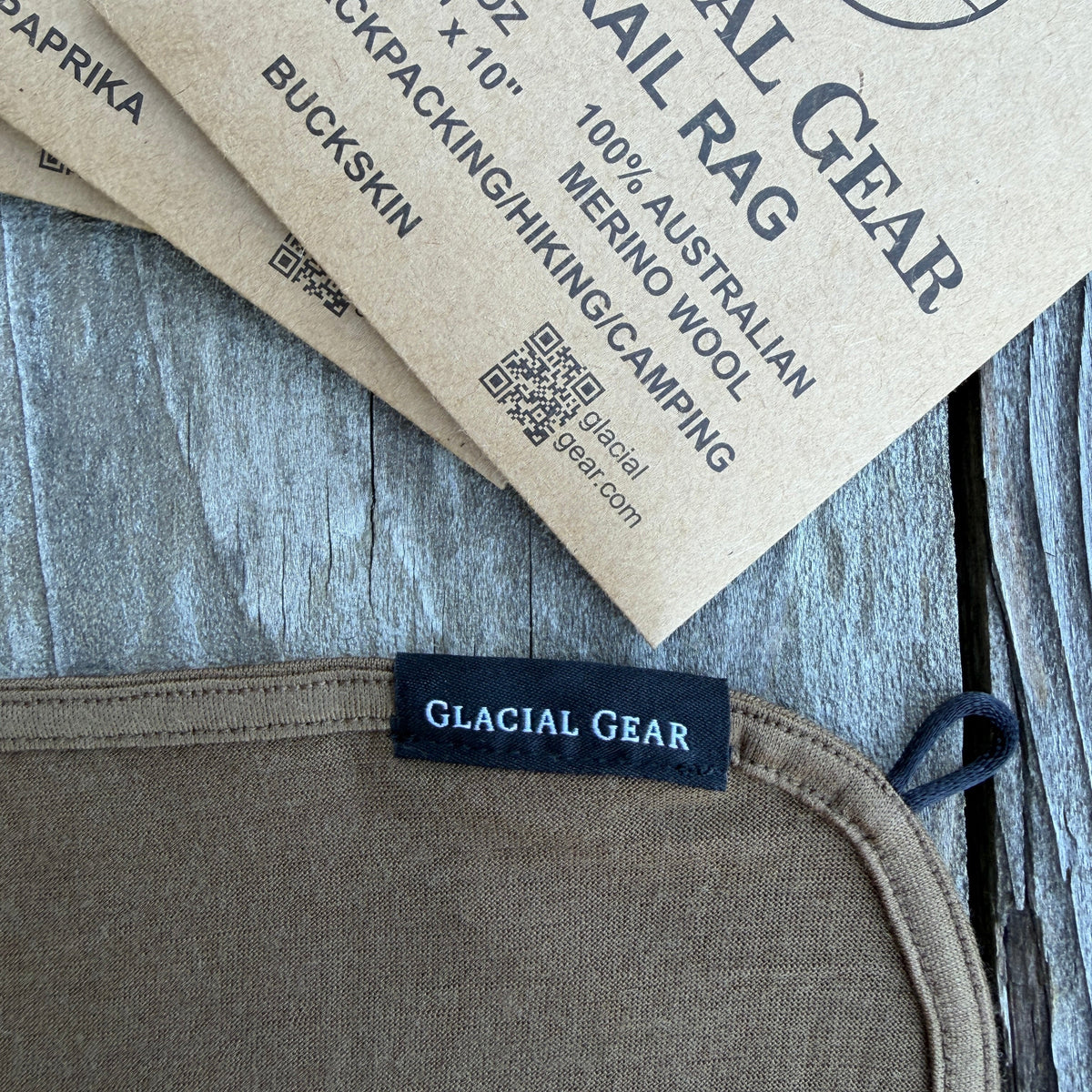 Glacial Gear label on a brown fabric item with a wooden background