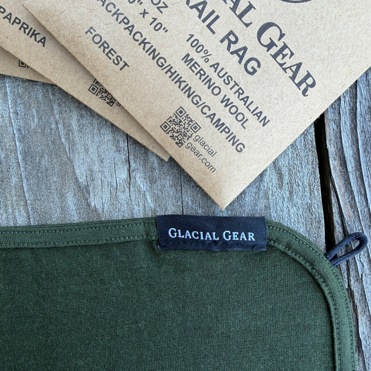 Green fabric with Glacial Gear label on a wooden surface