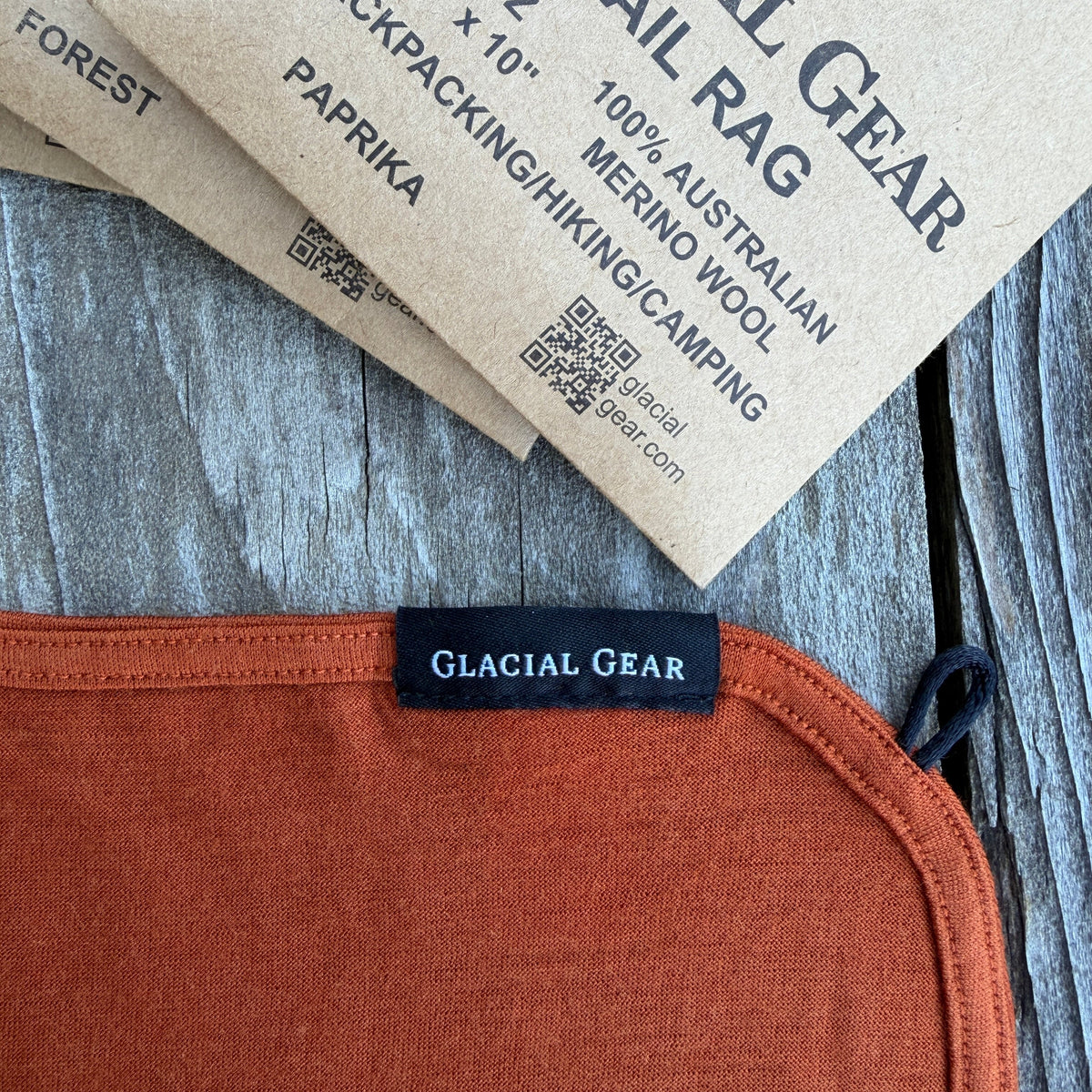 Glacial Gear label on a piece of orange fabric with packaging in the background.