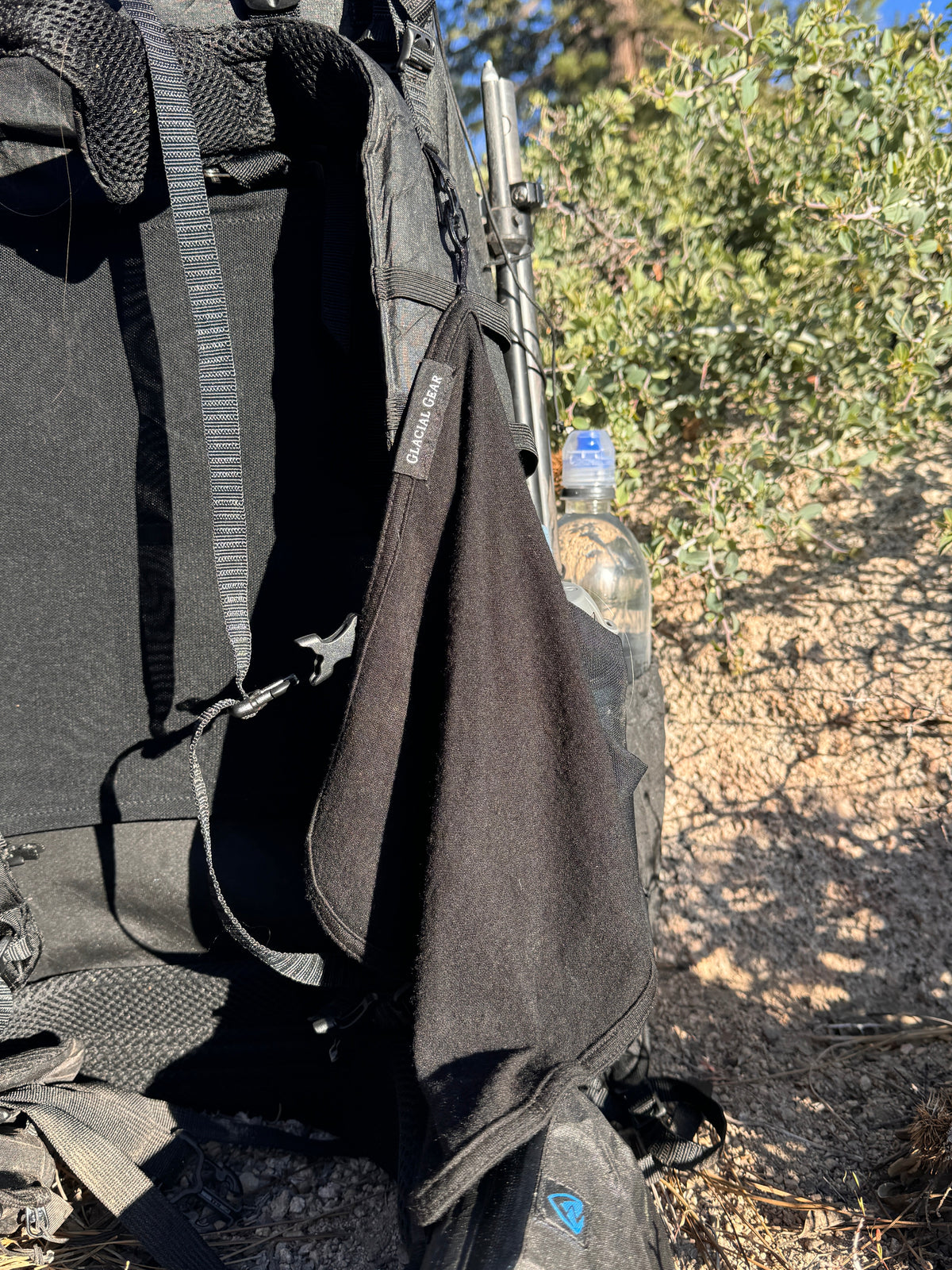 Backpack with a water bottle on a natural outdoor background