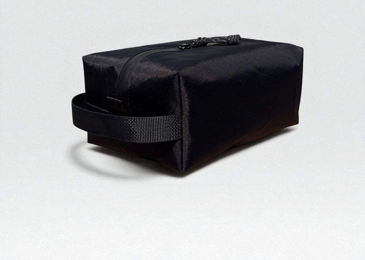 Black toiletry bag on a light gray background
