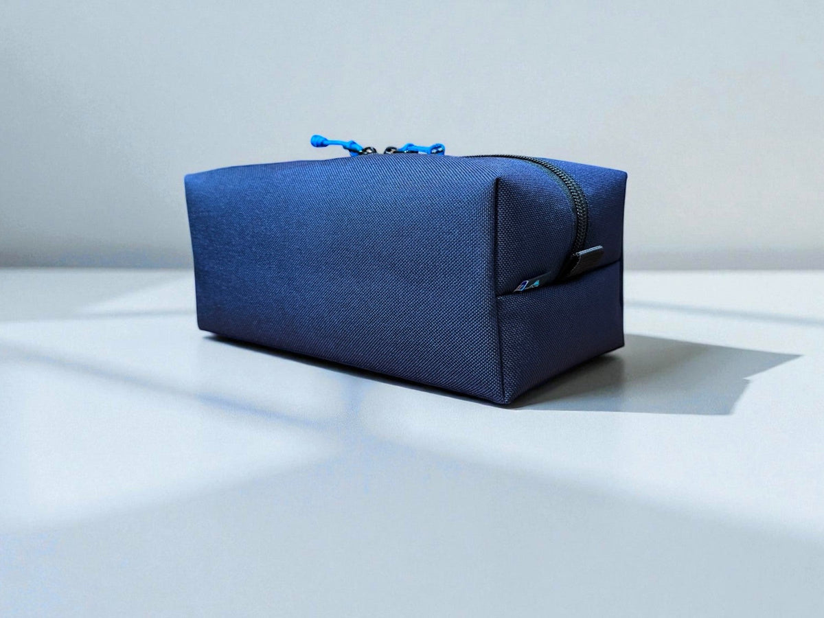 Blue toiletry bag on a light gray background