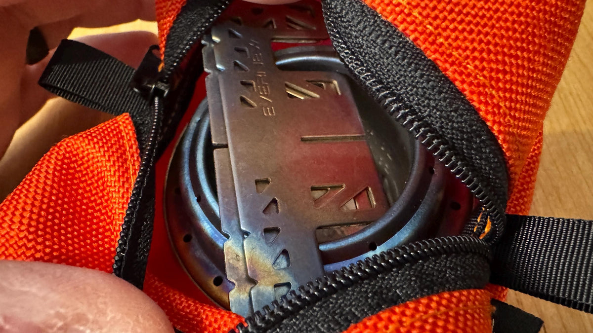 Close-up of a metal object with 'Zebra' branding inside an orange bag.