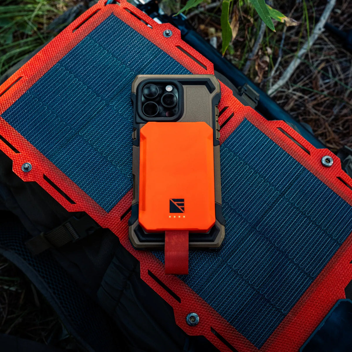 Phone case with solar panel and orange back on a natural background