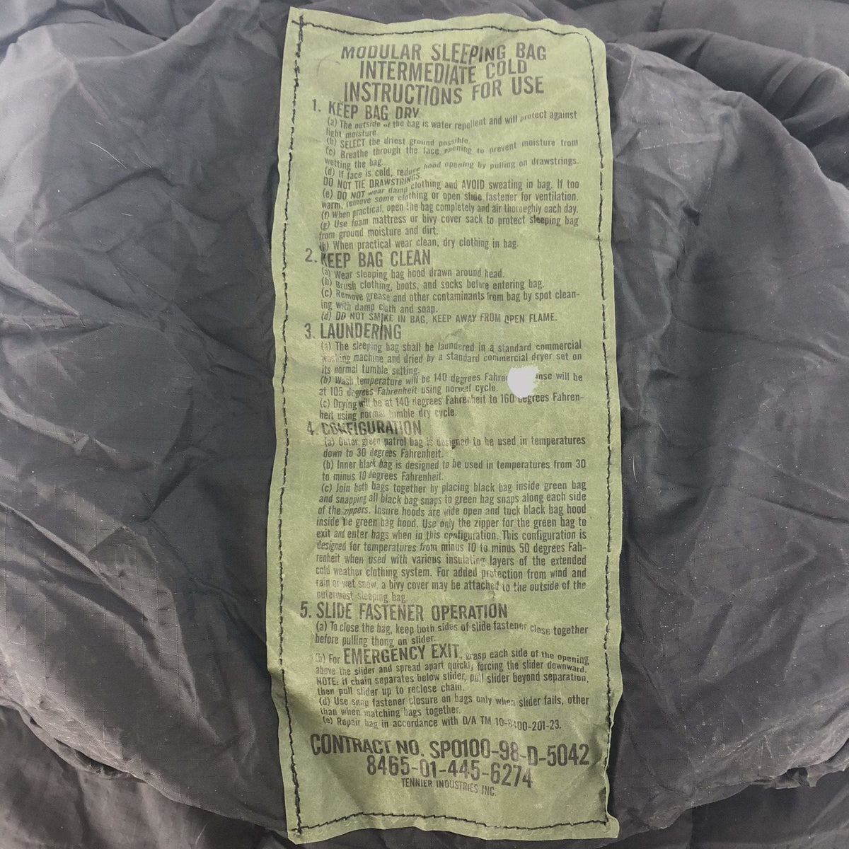 Sleeping bag with a label on a dark background