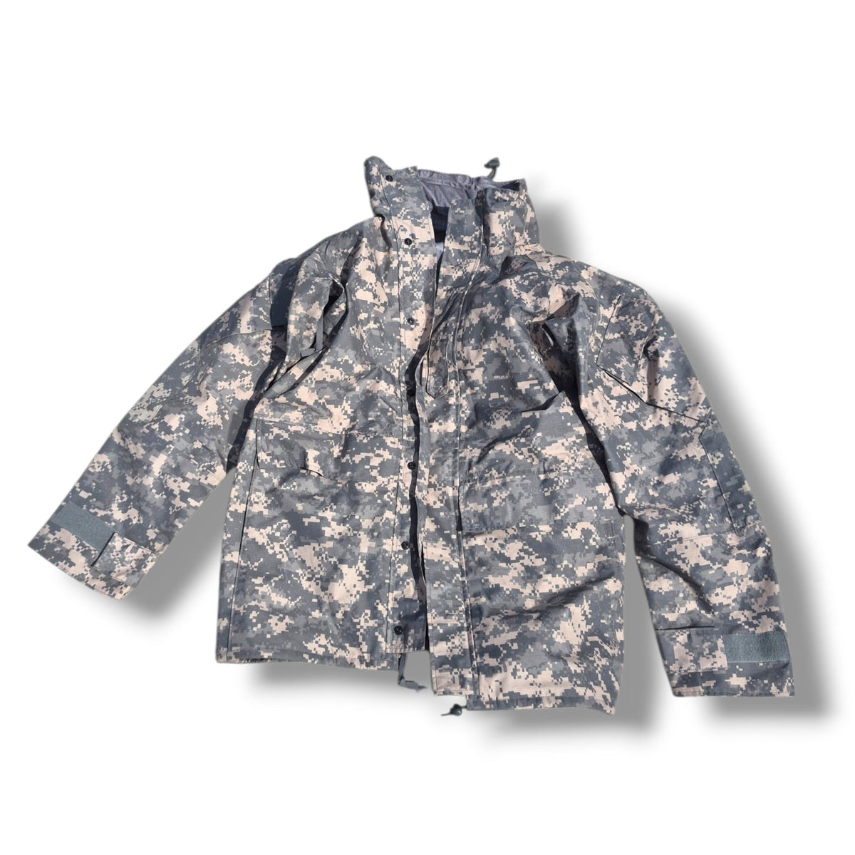 A digital camouflage utility jacket in a gray and beige pattern, shown flat against a white background with a drop shadow.
