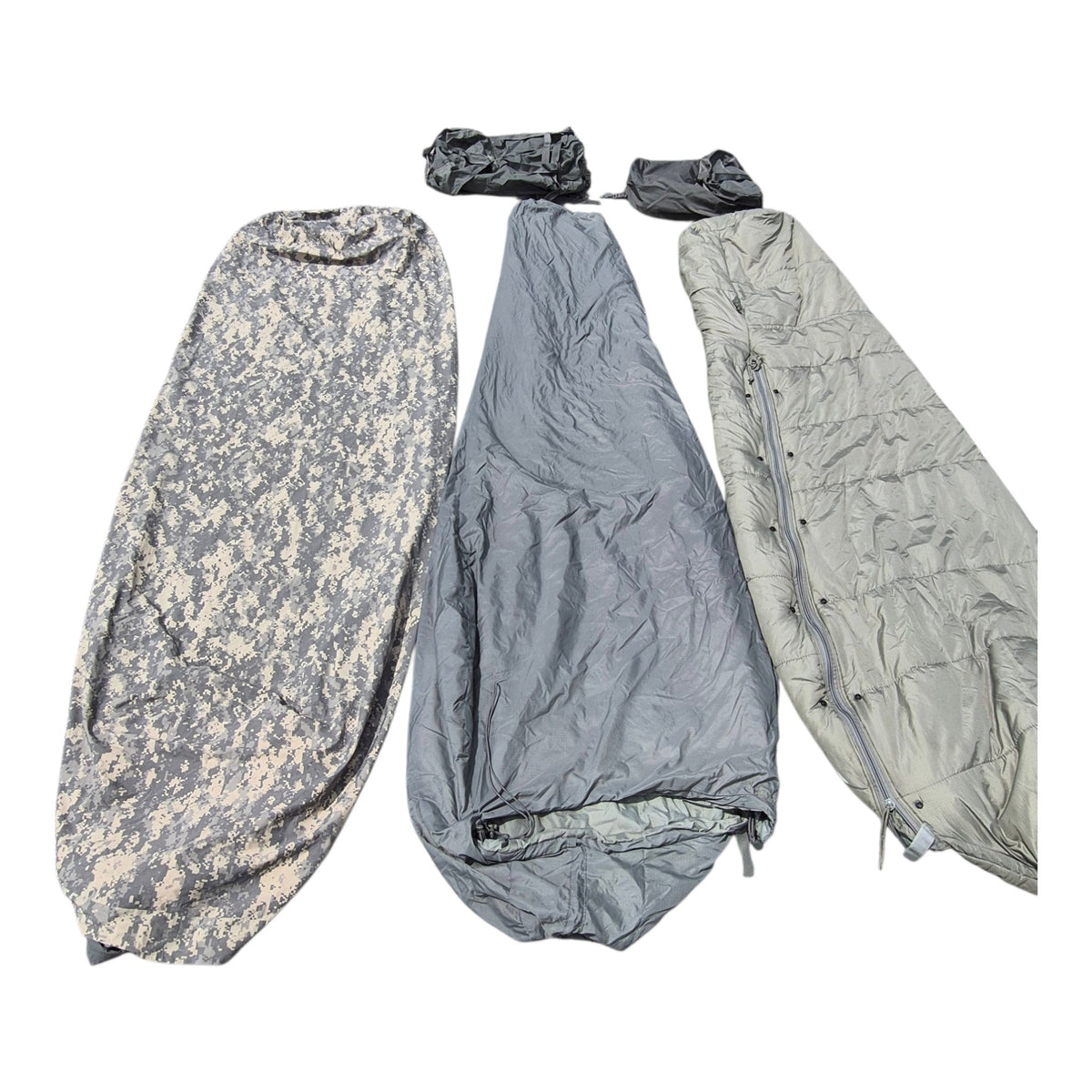 Three camouflage and solid-color sleeping bags laid out side by side on a white background, including two small matching accessories at the top.